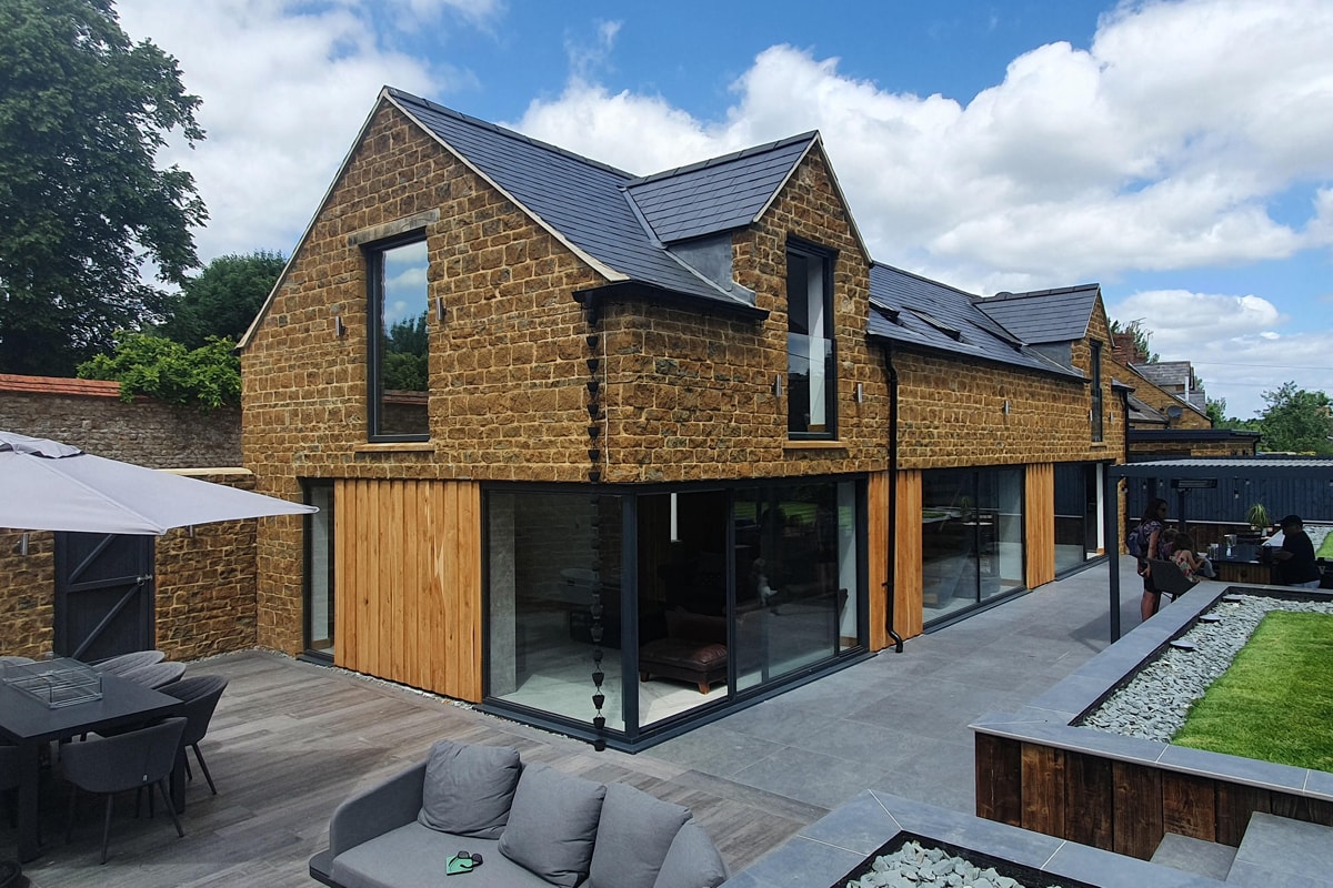 Milton Oxfordshire shortlisted for the Build It Awards 2022 glass extension glass Juliet balcony Cotswold stone outdoor seating